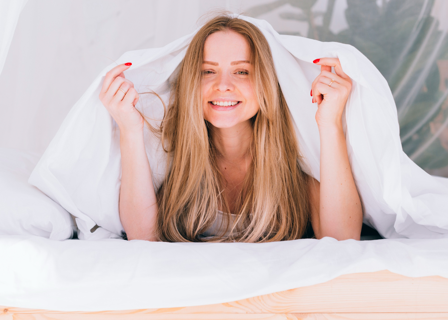 blonde girl posing with bed sheets